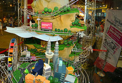 A detailed miniature Malaysia with landmarks such as the Petronas Twin Towers, with a ball track running through it